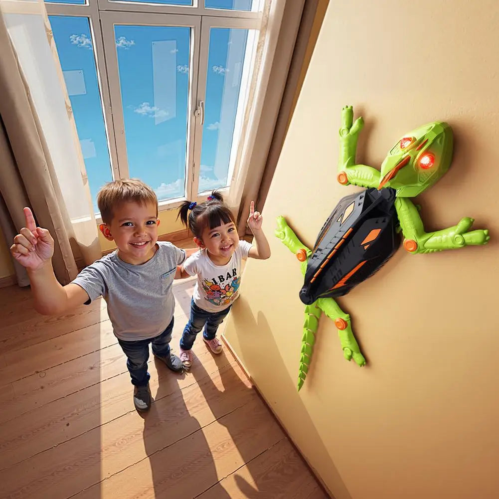 Two children standing next to a green toy frog on a wall.