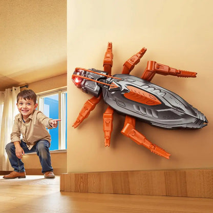 Child pointing at a large toy spider on a wall