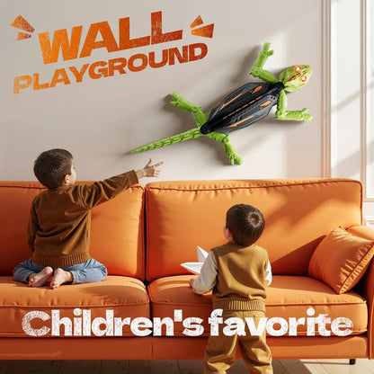 Two children playing with a toy wall climber on an orange couch, with 'Wall Playground' branding.